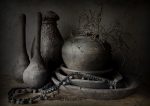 Sober gray still life with earthenware pots, bowls, and branches on a wooden background, 23.6x31.5 inches.